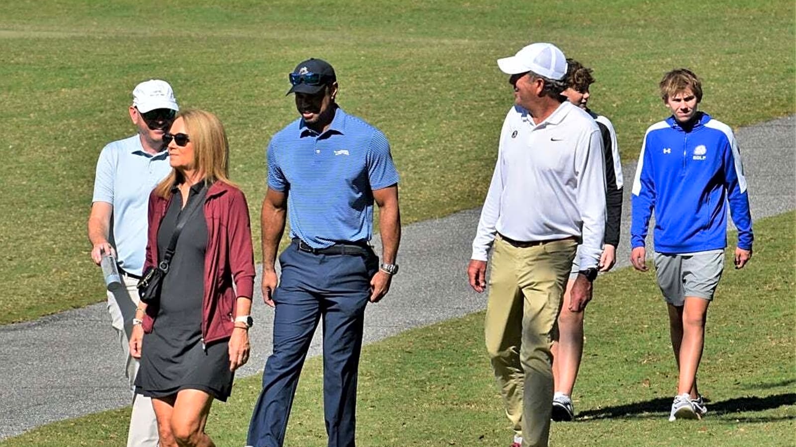 Line forming to recruit Charlie Woods ('27) with Tiger along for ride