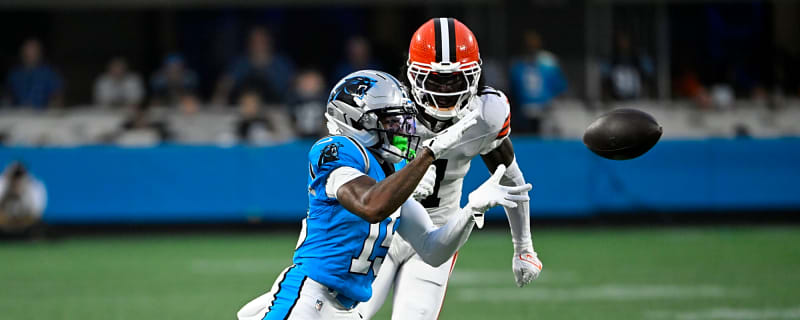 Shirtless Tony Brown walks around with wooden sickle before Browns-Panthers preseason game