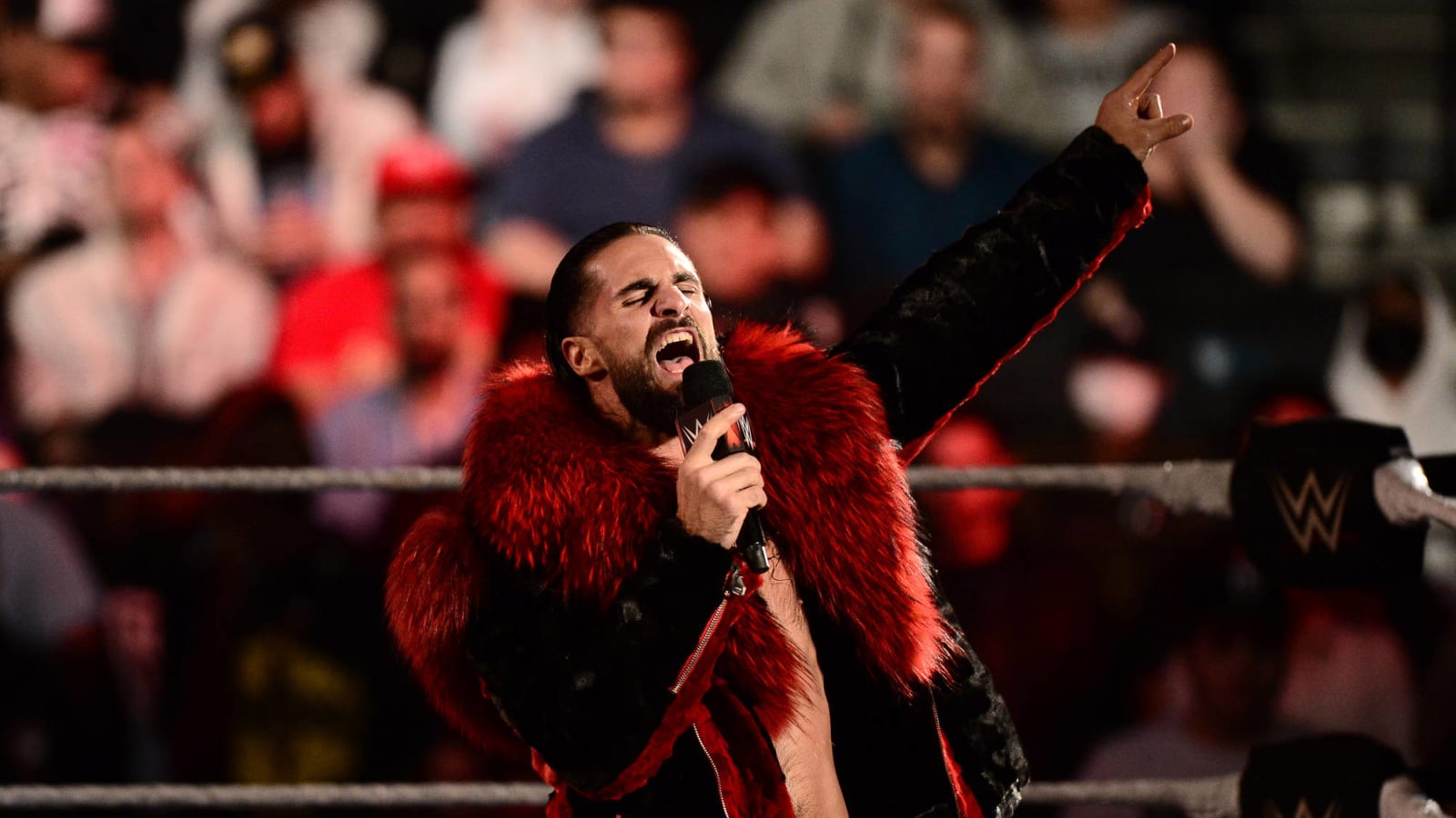 Fan attacks wrestler Seth Rollins during WWE Raw