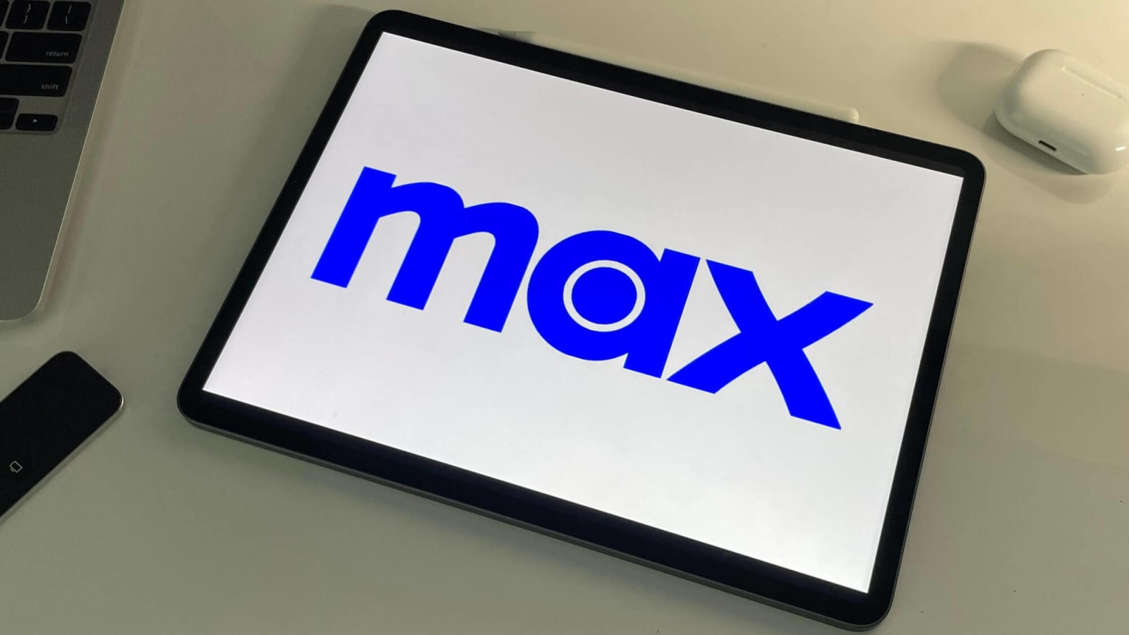 Max logo against a white background on a tablet on a desk