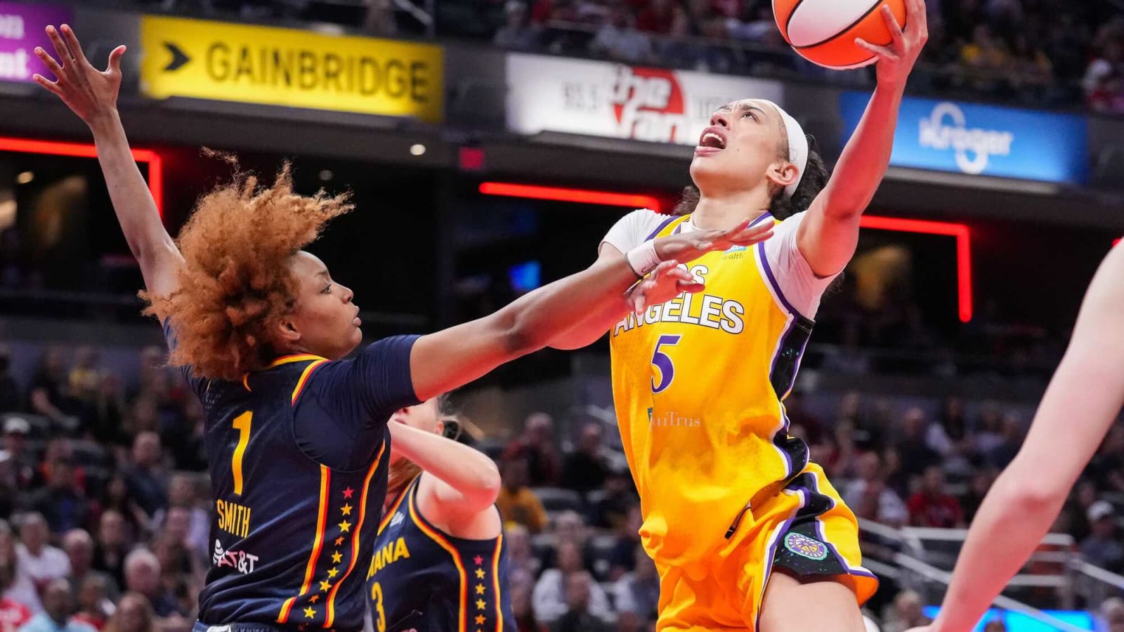 Sparks forward Dearica Hamby drives for a layup against Fever forward NaLyssa Smith at Gainbridge Fieldhouse