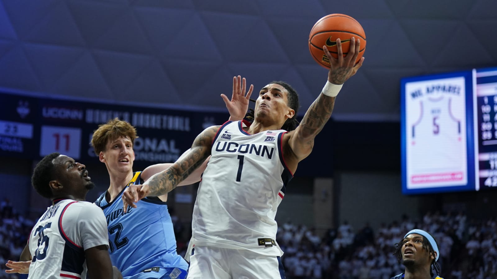UConn guard Solo Ball (1) drives to the basket against Marquette forward Ben Gold (12)