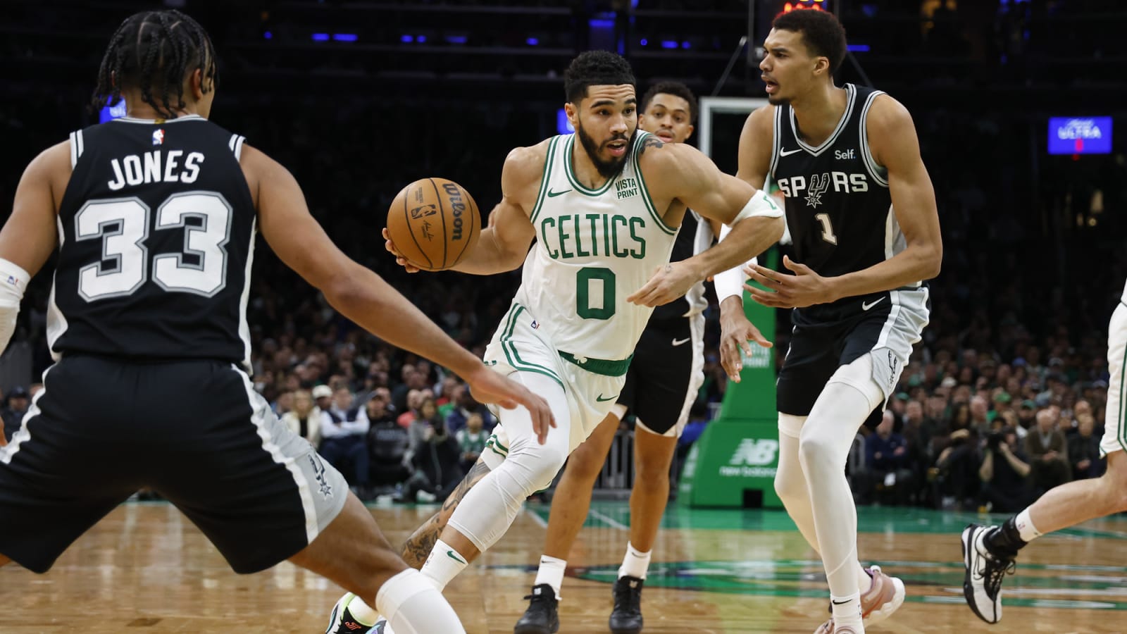Jayson Tatum drives past Victor Wembanyama at TD Garden