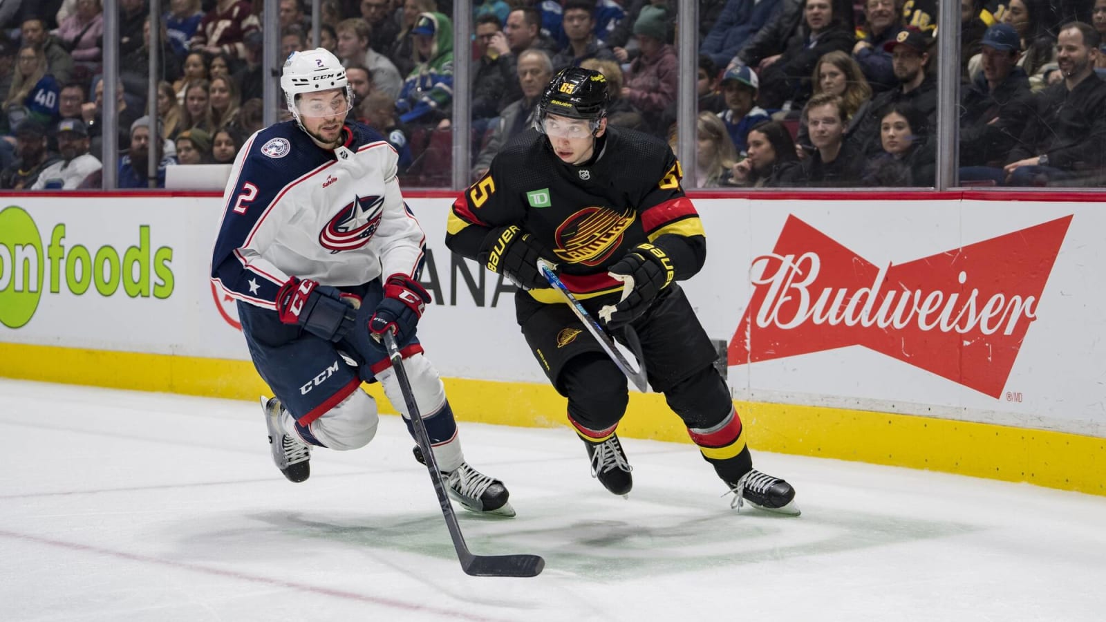Which defenders might the Canucks be 'peeking at' as they seek an early season trade?