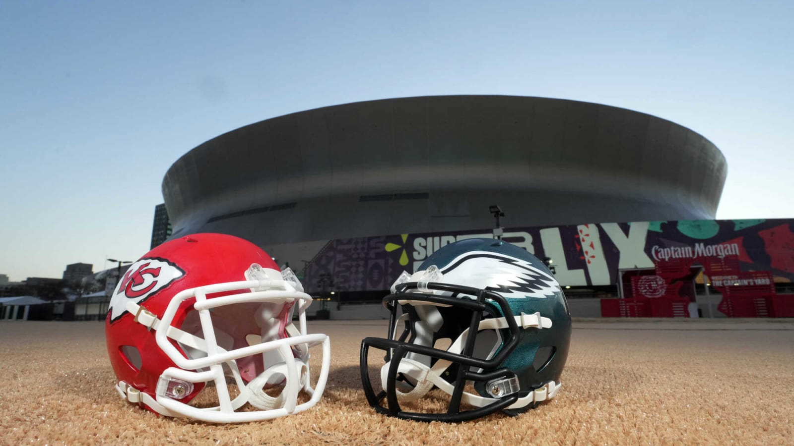 Kansas City Chiefs and Philadelphia Eagles helmets in front of Caesars Superdome with forced perspective for Super Bowl LIX