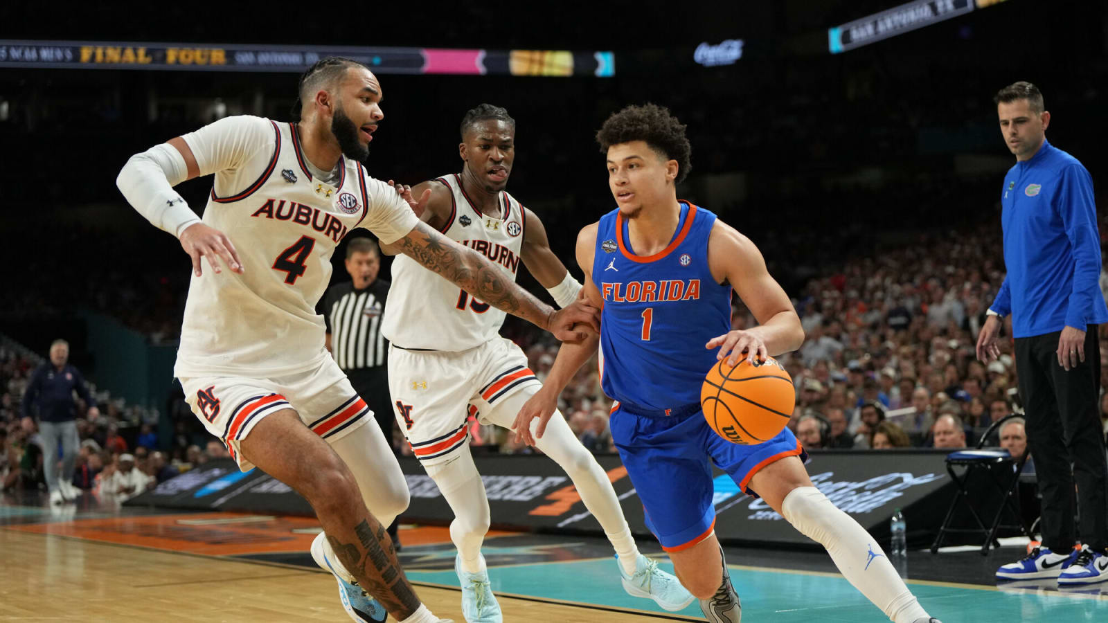 Florida guard Walter Clayton Jr. dribbles against Auburn forward Johni Broome during the Final Four at the Alamodome.