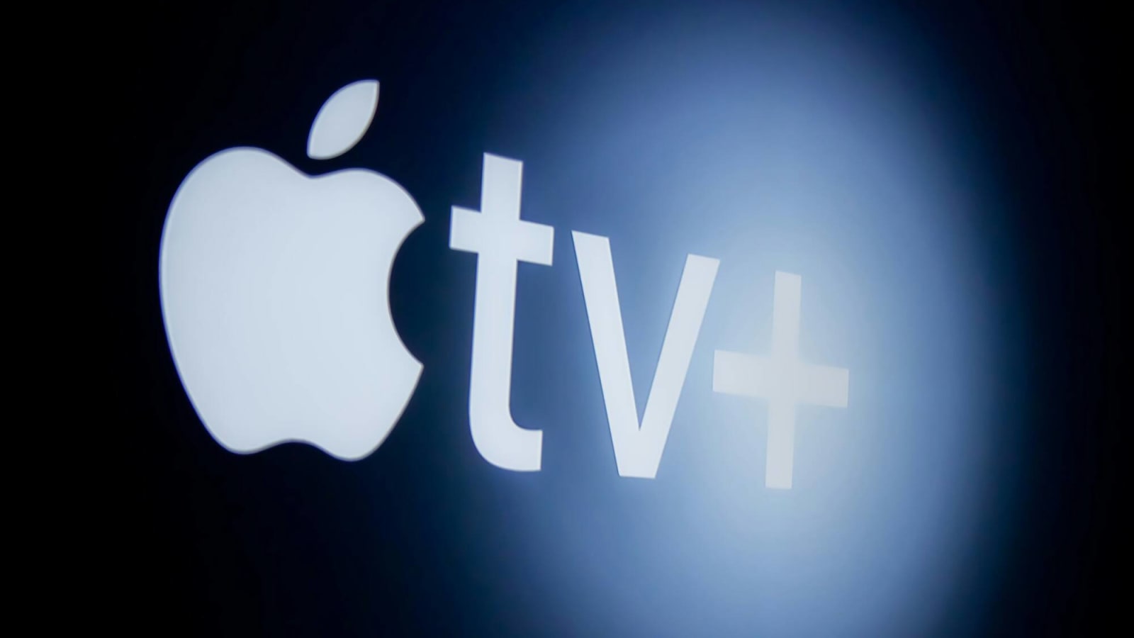 Standard Apple TV Logo in white against a black background on a flatscreen TV with shimmer affect