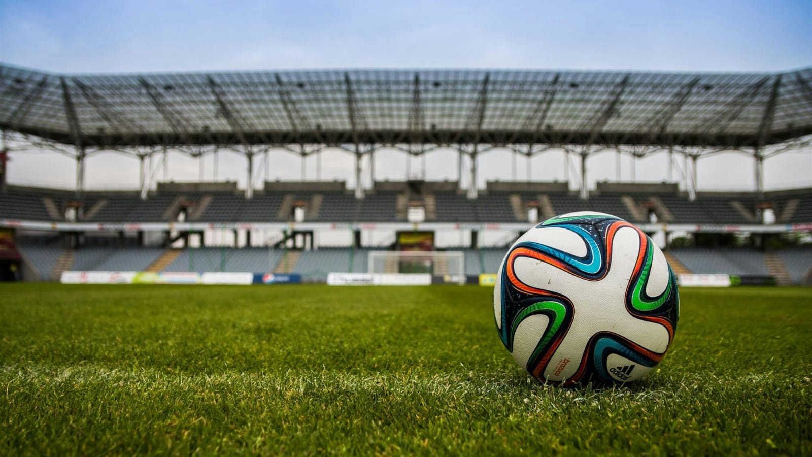 Colorful soccer ball on a field in a stadium