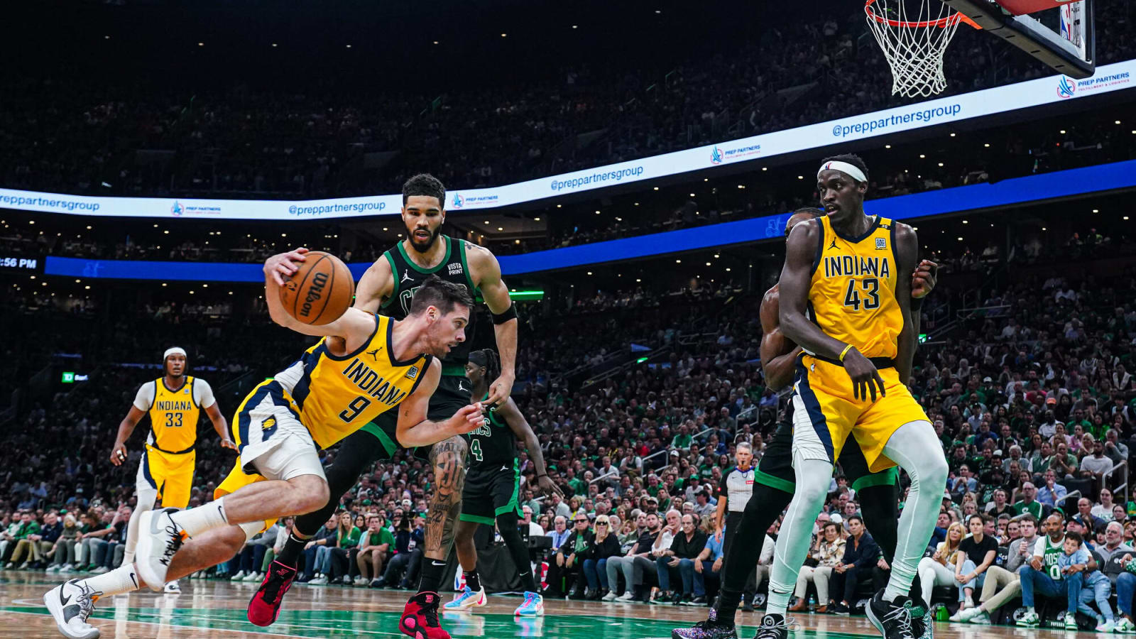 T.J. McConnell drives past Jayson Tatum at TD Garden