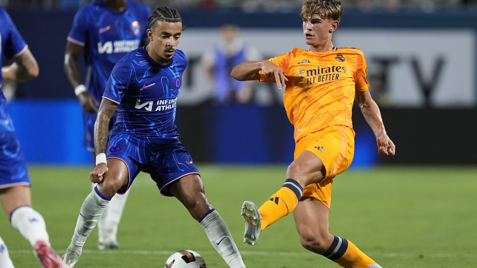 Real Madrid's Nico Paz kicks the ball against Chelsea's Christopher Nkunku at Bank of America Stadium