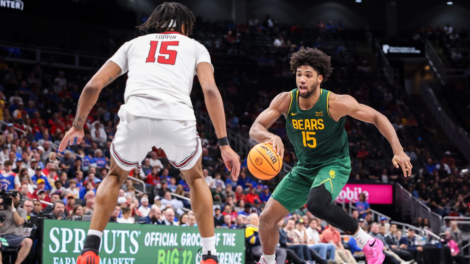 Baylor forward Norchad Omier (15) dribbles while defended by Texas Tech forward JT Toppin (15) in Kansas City.