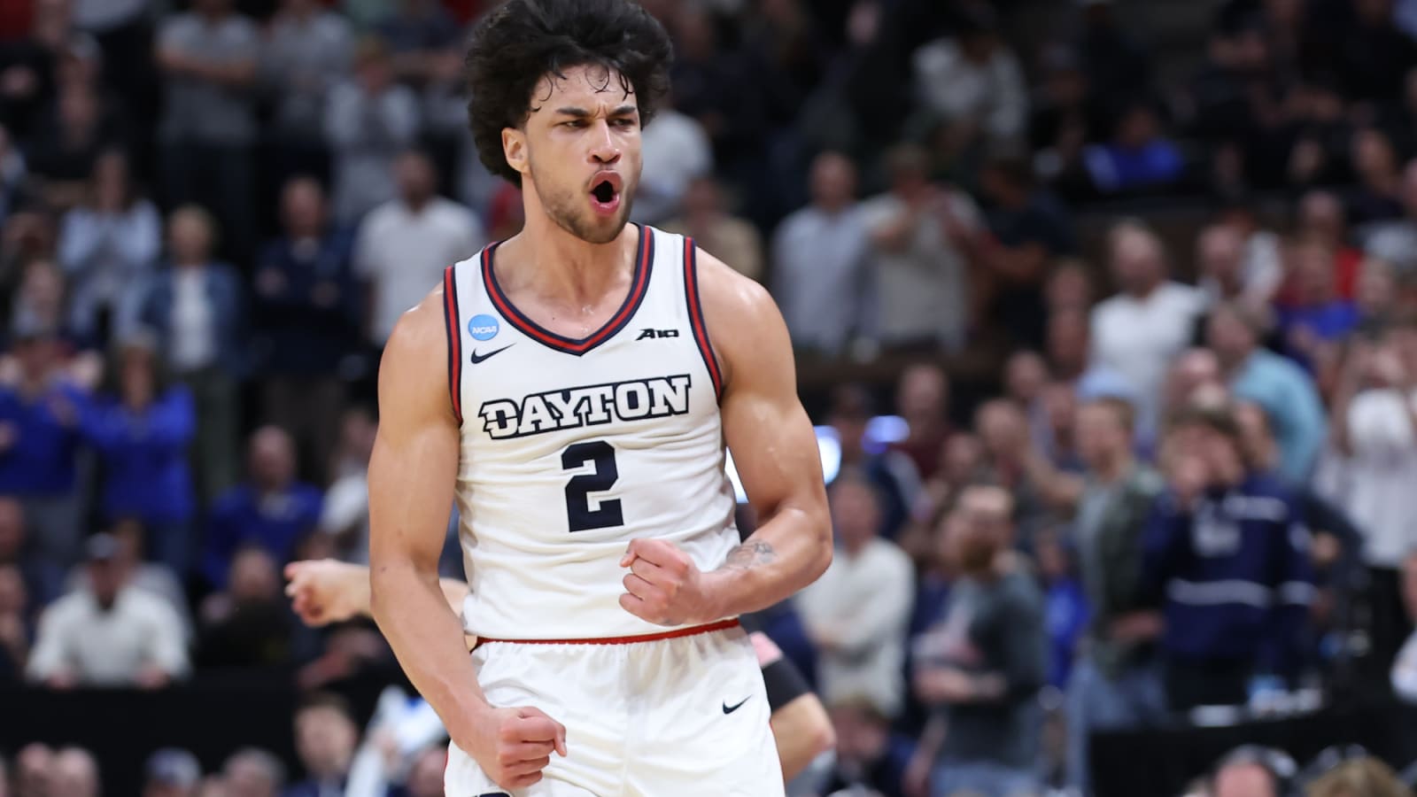 Dayton Flyers forward Nate Santos (2) celebrates and flexes on court