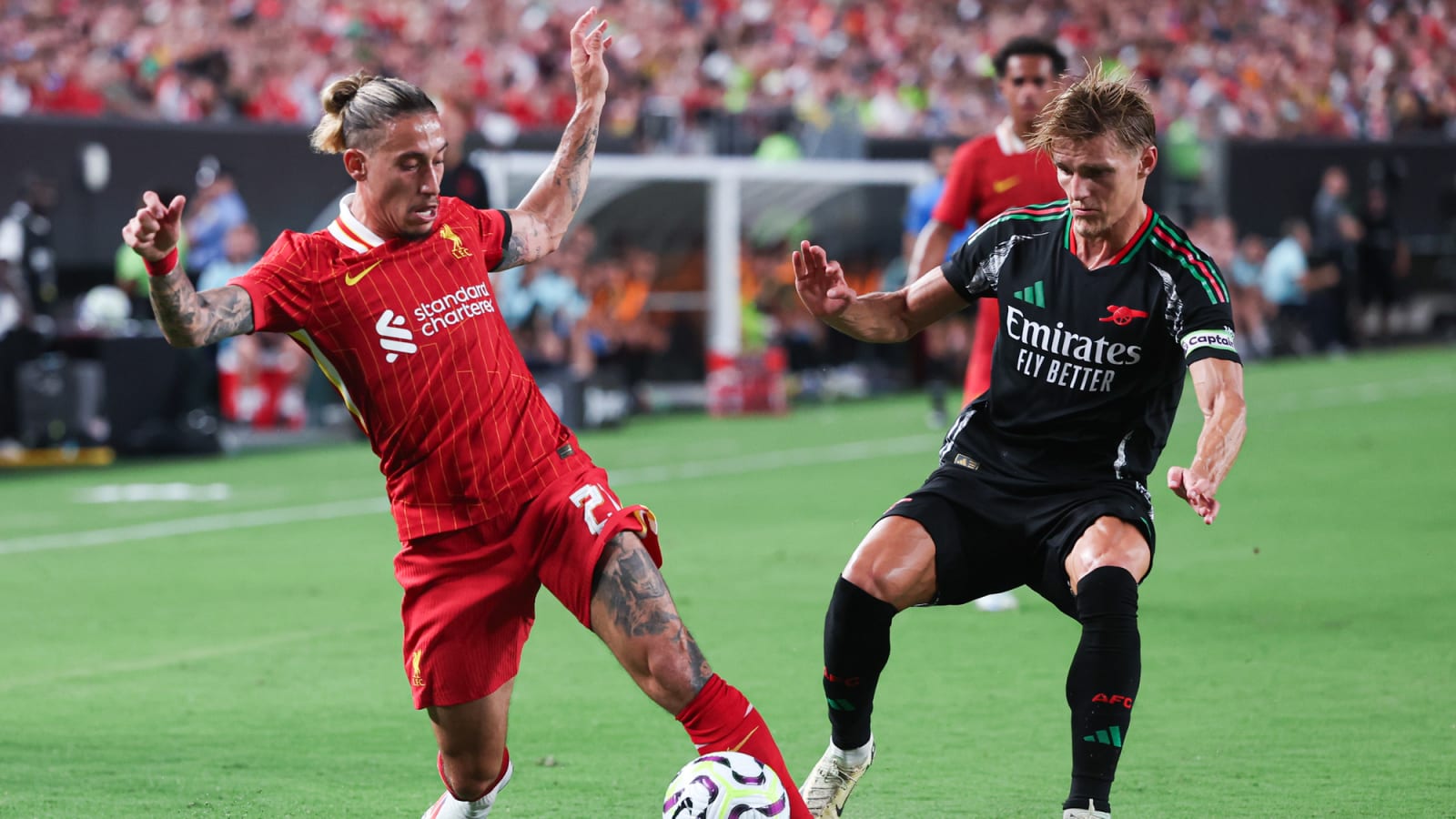 Liverpool's Kostas Tsimikas controls ball against Arsenal's Martin Odegaard