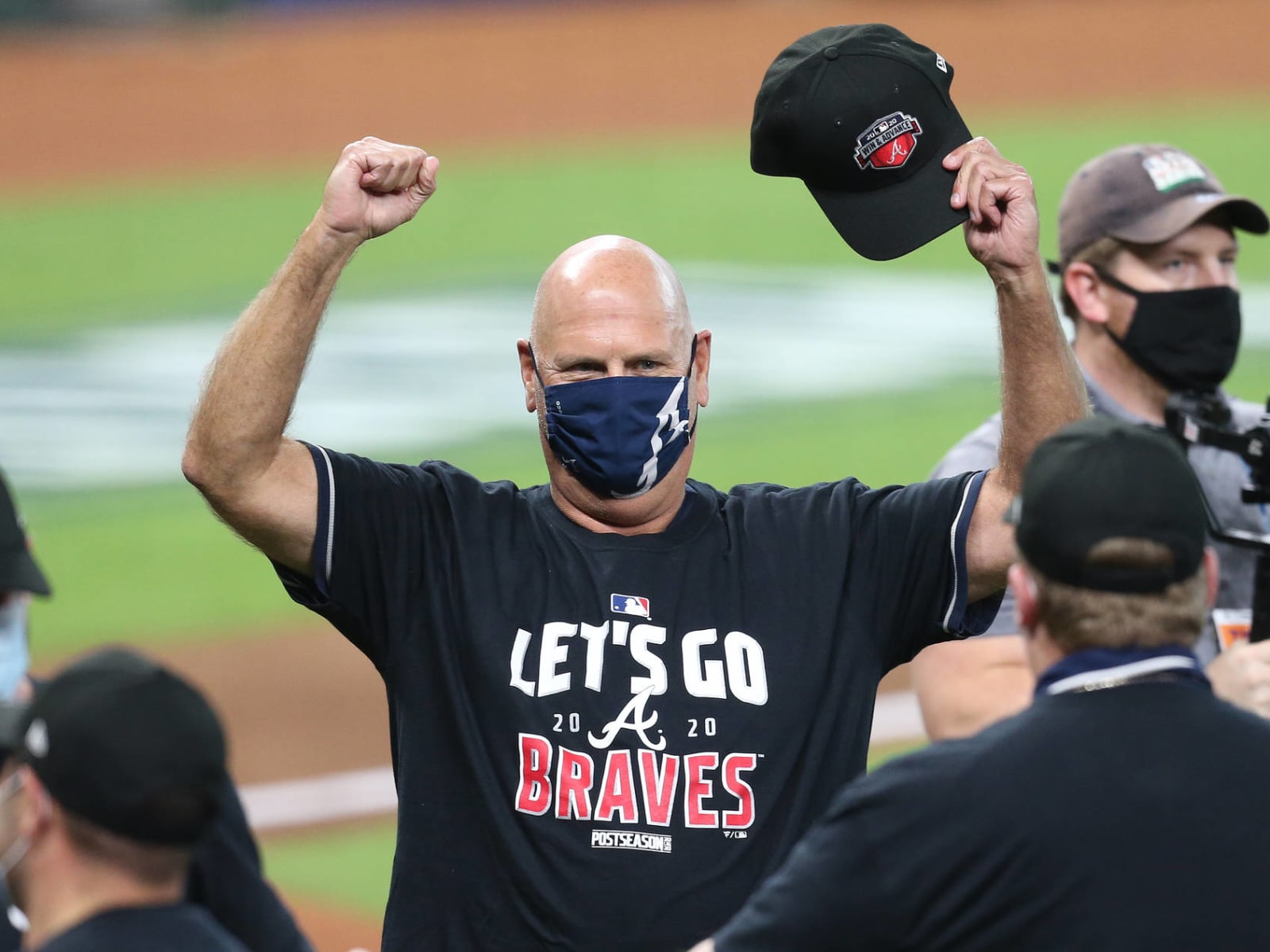 Atlanta Braves manager Brian Snitker signs an autograph before a