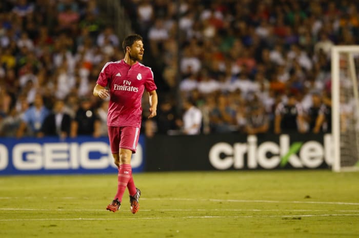 Nigel de Jong kicks Xabi Alonso