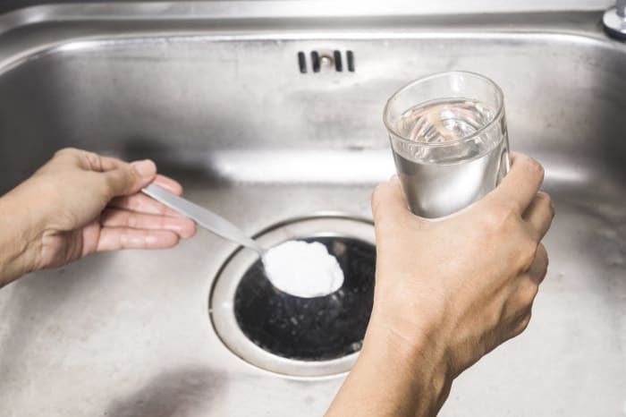 Combine baking soda and vinegar to remove drain odors