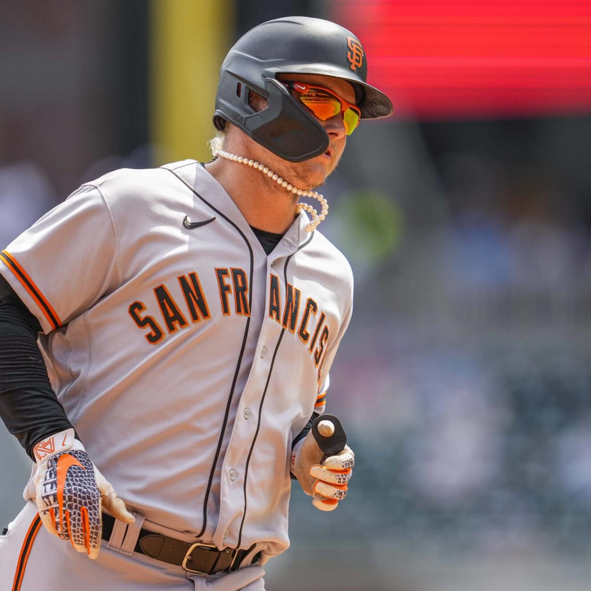 Joc Pederson of the Atlanta Braves puts a batting helmet over his