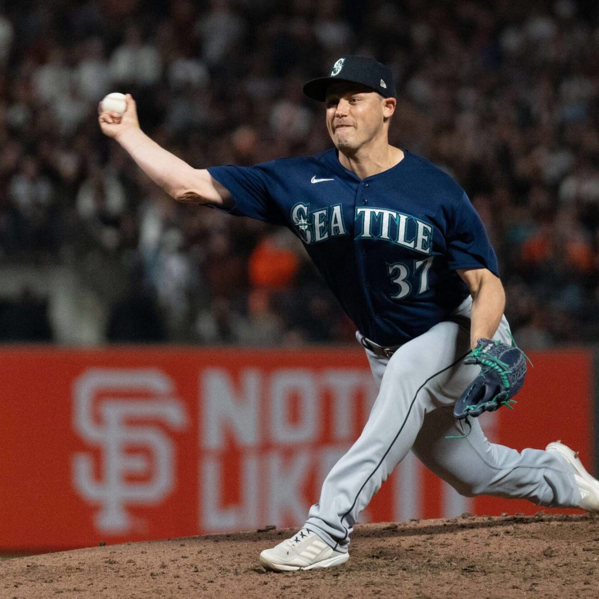 Mariners pitcher Paul Sewald reacts to Blue Jays merchandise being