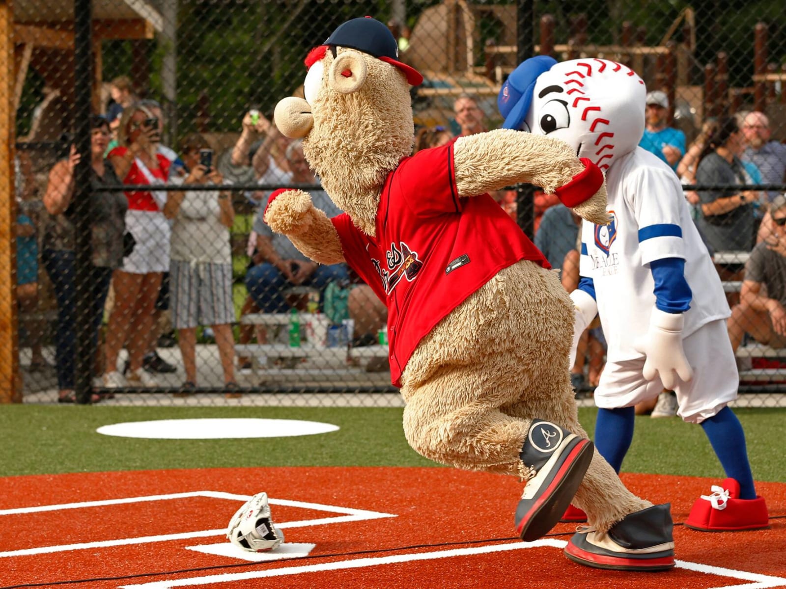 Atlanta Braves mascot Blooper dances on the dugout in honor of Los