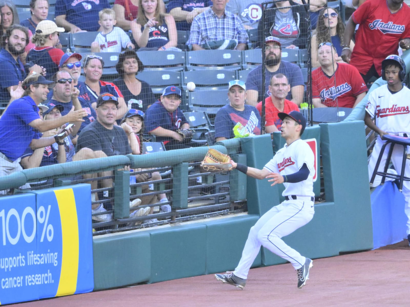 Steven Kwan takes a foul ball off the top of his head