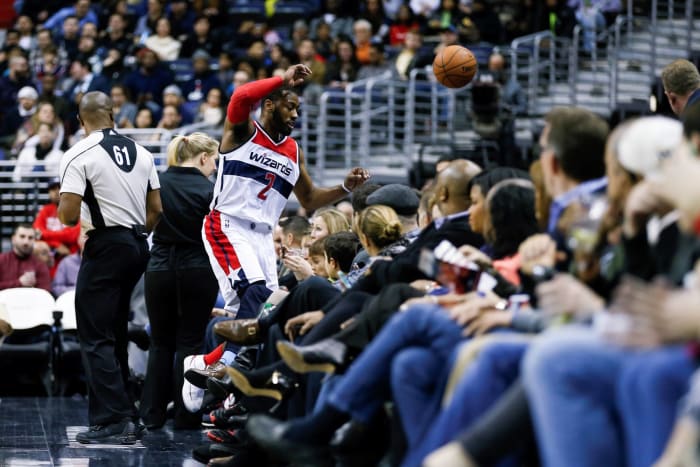 John Wall goes way into the crowd