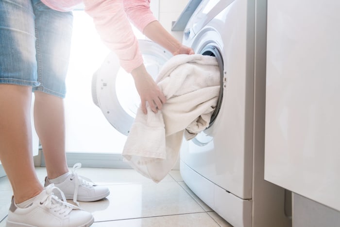 Add clean, dry towels to the dryer to speed the process along