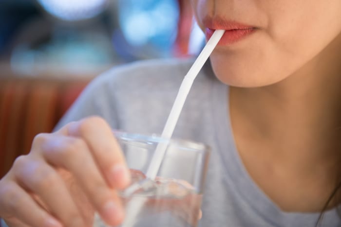Drink water through a straw