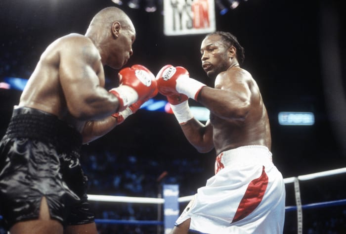 Lennox Lewis bests Mike Tyson
