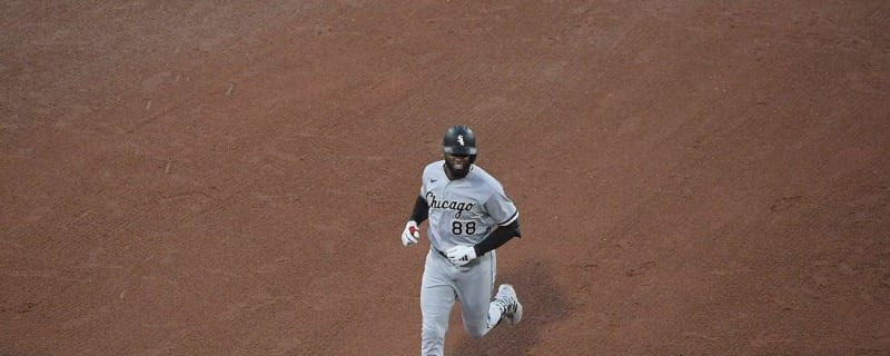 Chicago White Sox's Elvis Andrus, left, puts on the home run Southside  jacket and hat on Luis Robert Jr., right, after Robert hit a solo home run  against the Los Angeles Dodgers