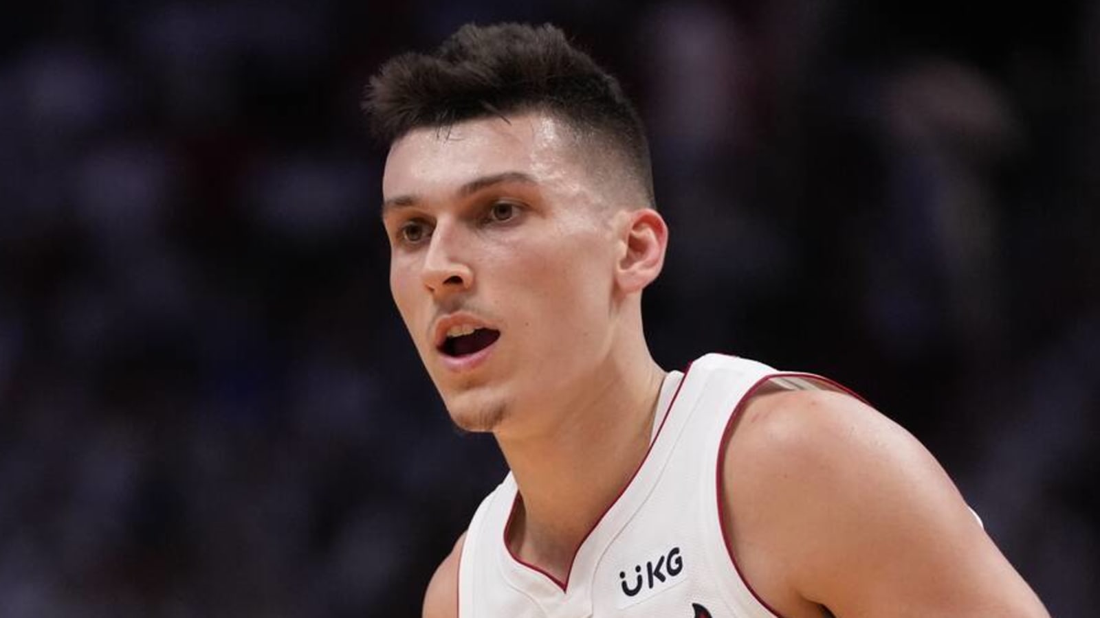 Tyler Herro wears beach outfit on bench during Game 5