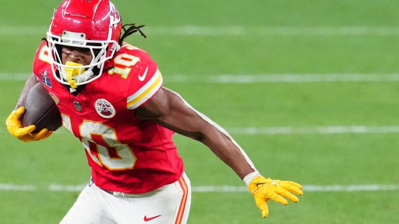 Isiah Pacheco carries live goat wearing Chiefs jersey during Super Bowl parade