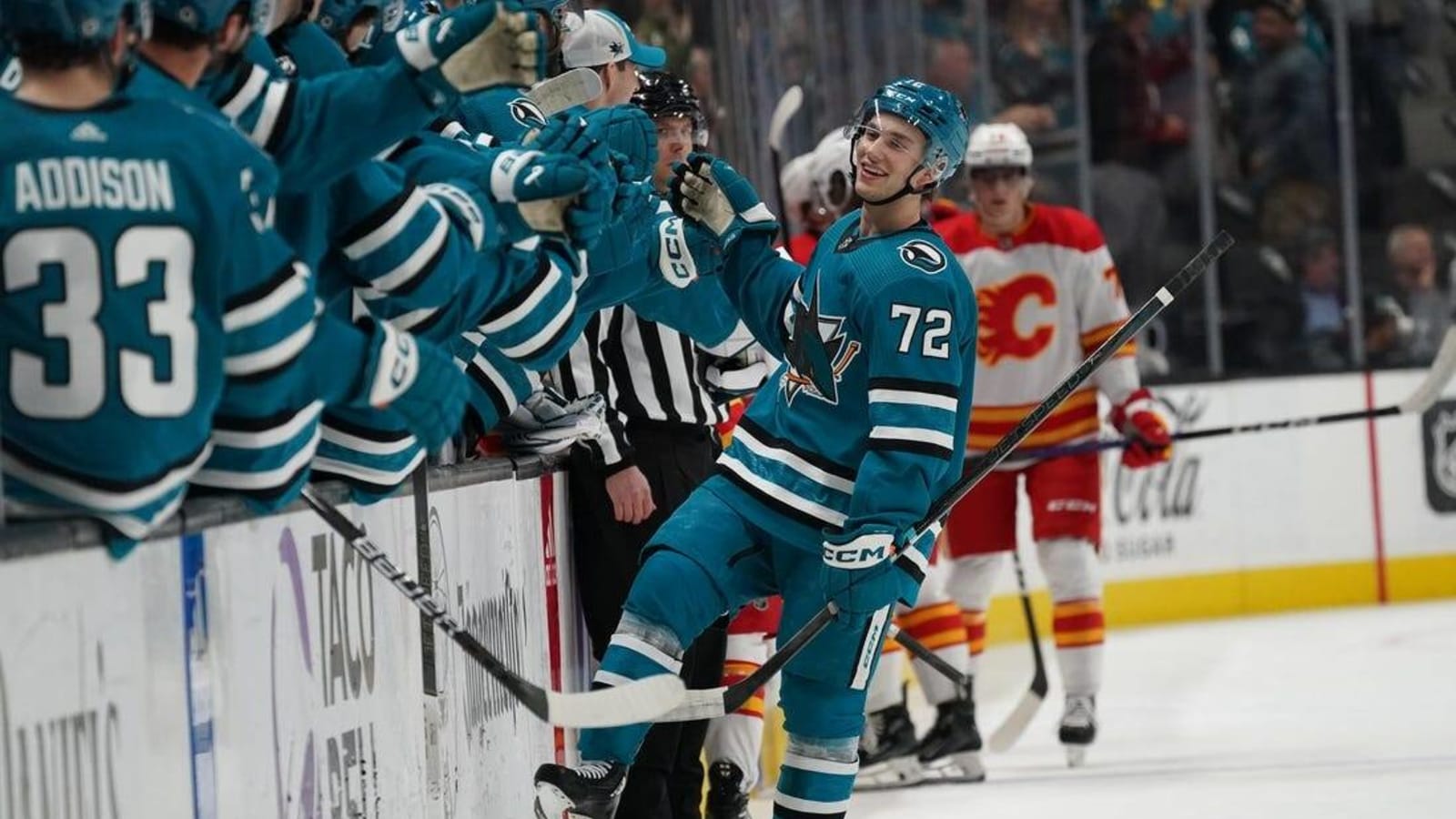 Flames fire up an OT win over Sharks