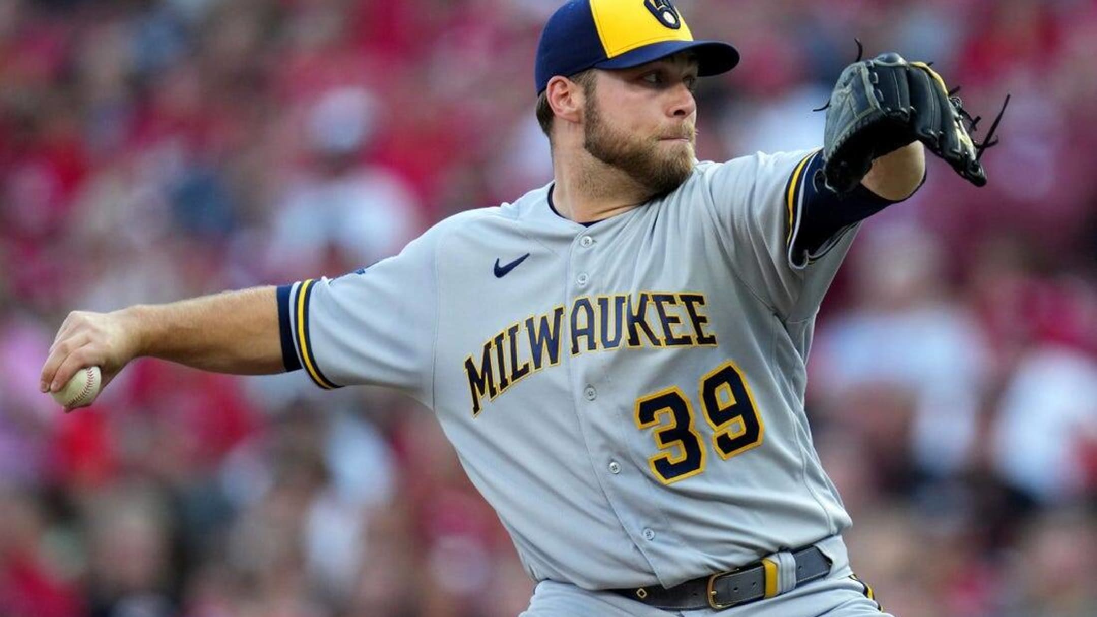 Milwaukee Brewers' Devin Williams pauses before pitching during