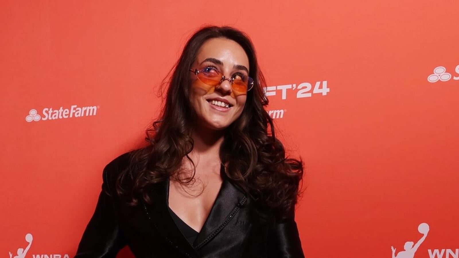 Nika Muhl shows off outfit at WNBA Draft orange carpet