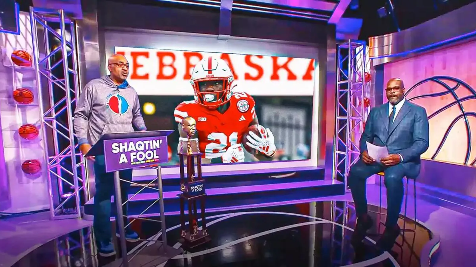 Nebraska football’s Emmett Johnson jumps over Matt Rhule during Slam Dunk Contest