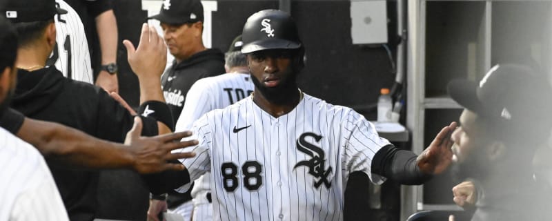 Chicago White Sox's Elvis Andrus, left, puts on the home run Southside  jacket and hat on Luis Robert Jr., right, after Robert hit a solo home run  against the Los Angeles Dodgers