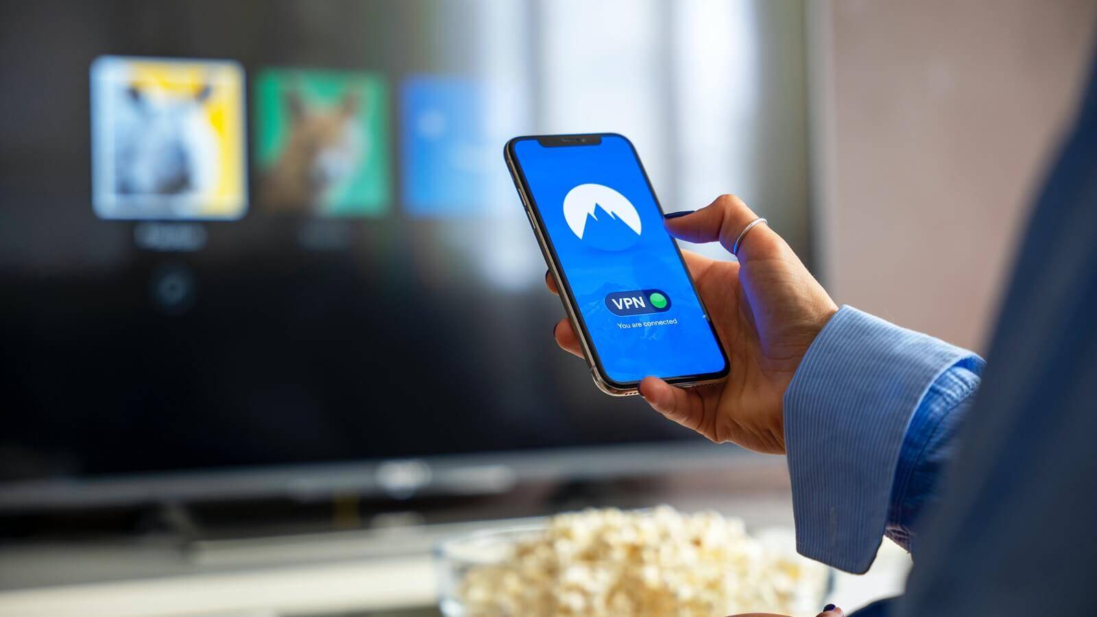 Person holding cell phone with VPN displaying