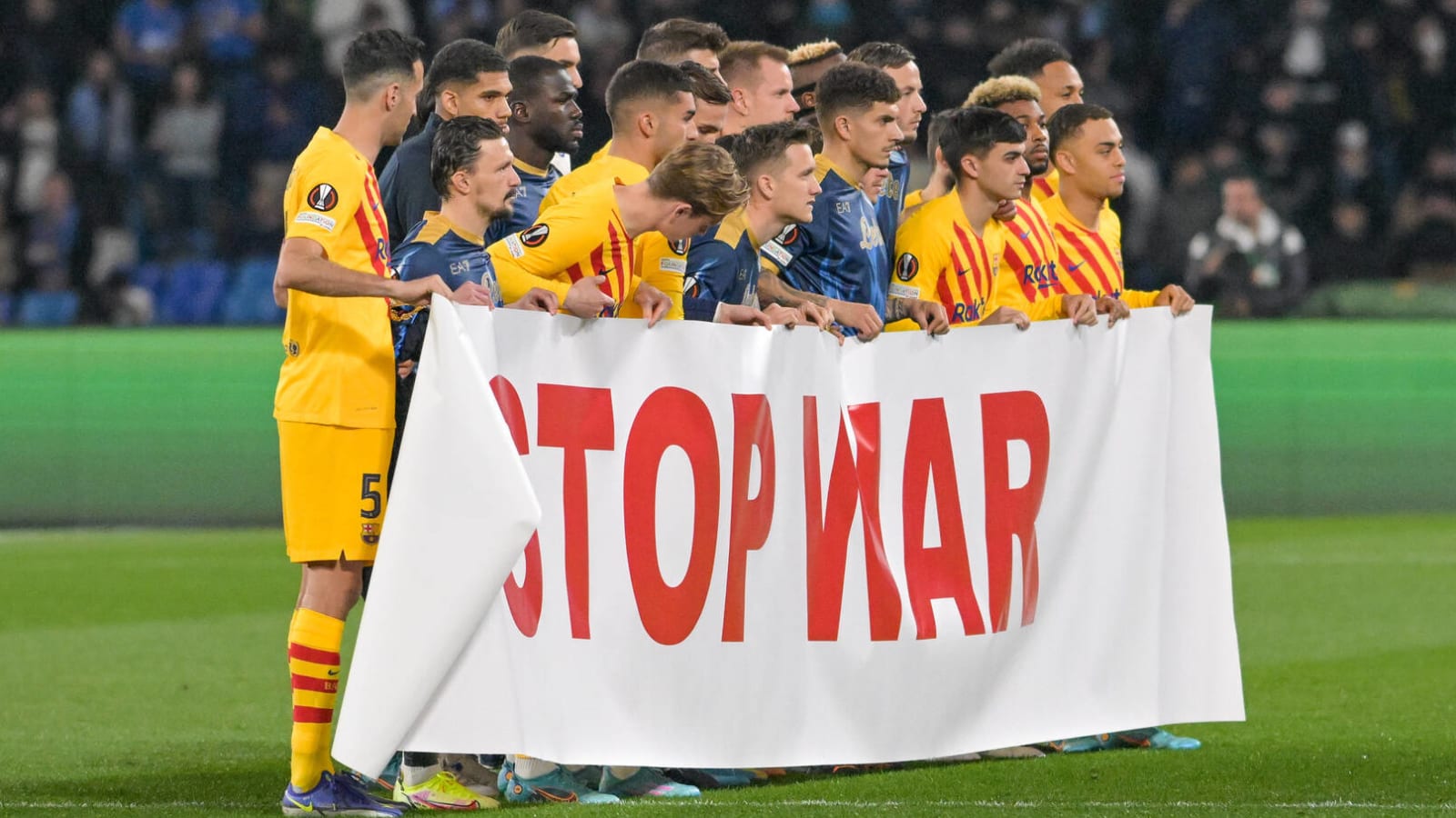 Barcelona, Napoli players hold 'Stop War' banner before match