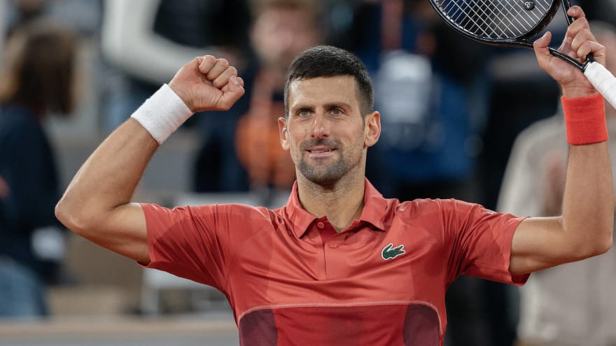 Djokovic overcomes knee injury, making history at French Open
