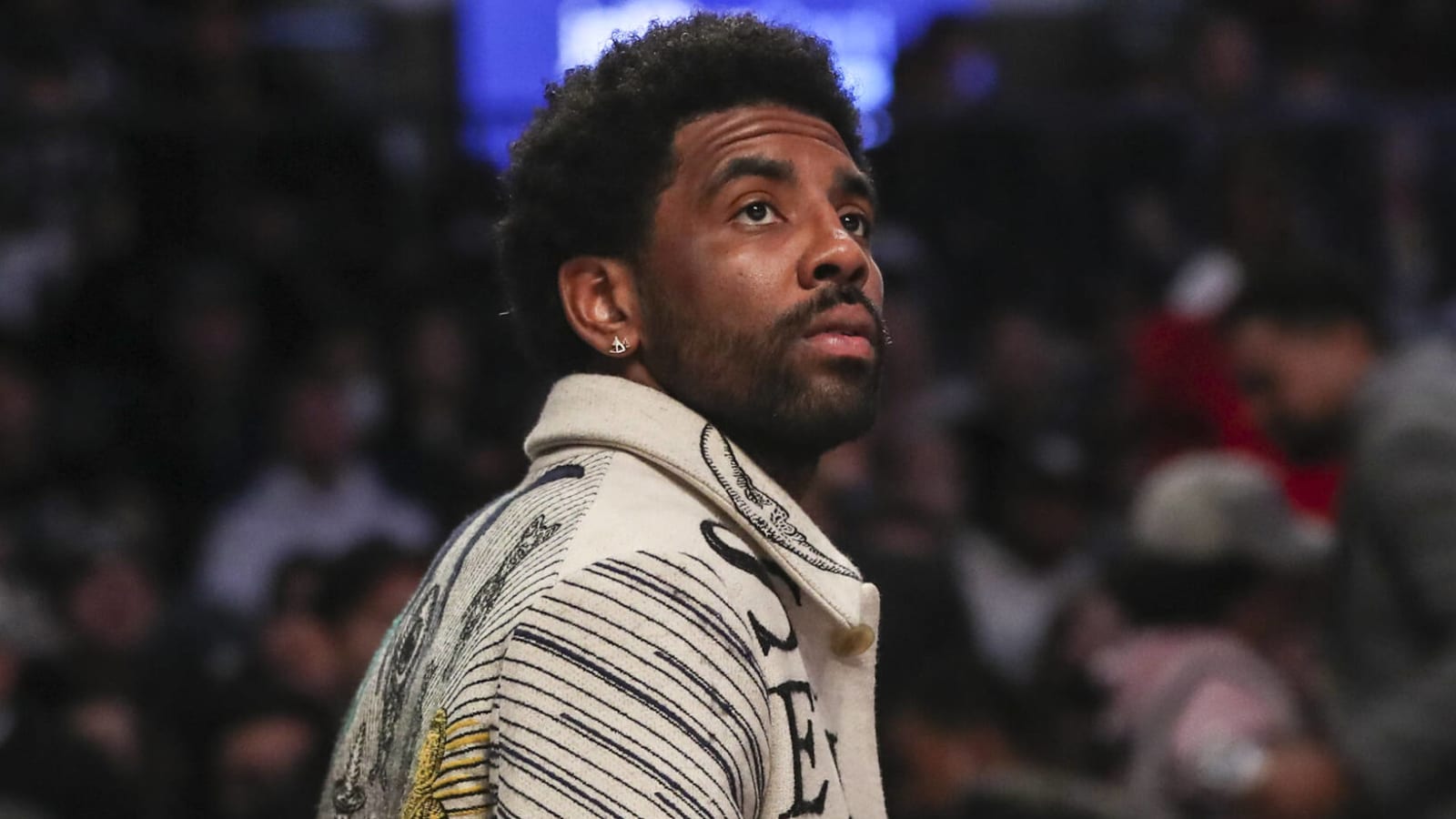 Kyrie Irving sitting courtside at Nets 