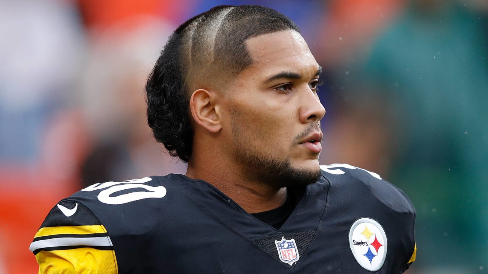 Podcast host makes good on haircut bet with James Conner