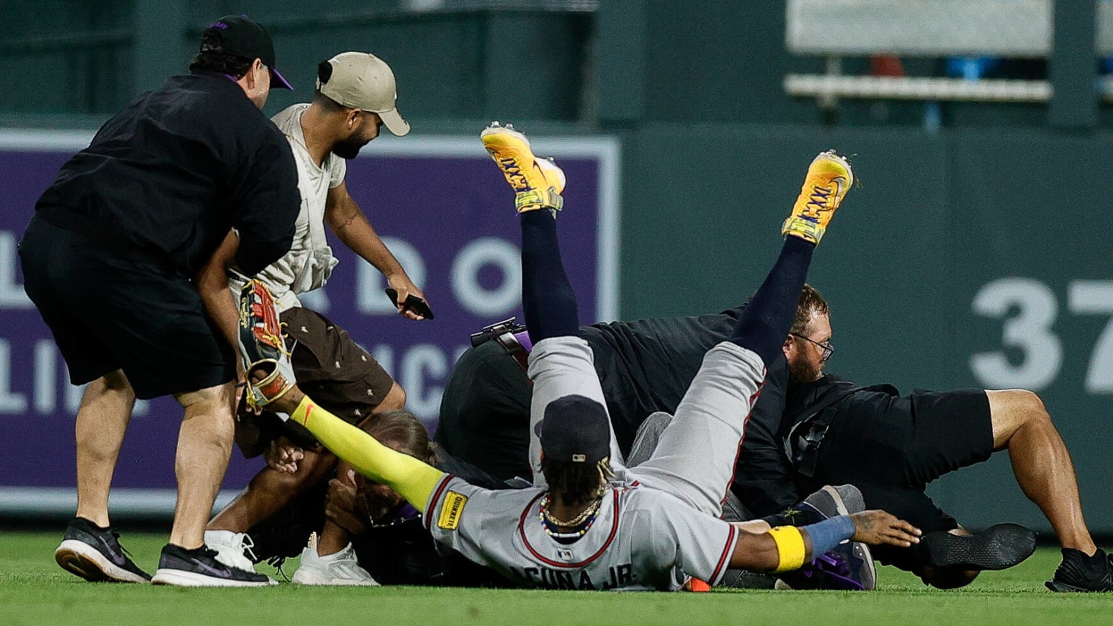 Watch: Ronald Acuna Jr. tackled when fans storm Coors Field