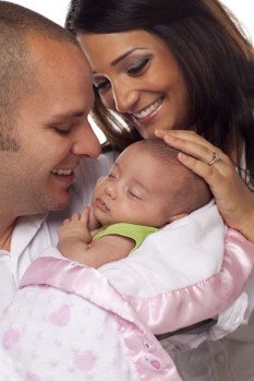 Parents holding new baby