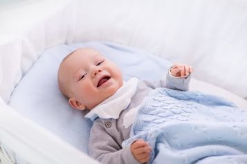 Baby smiling in crib