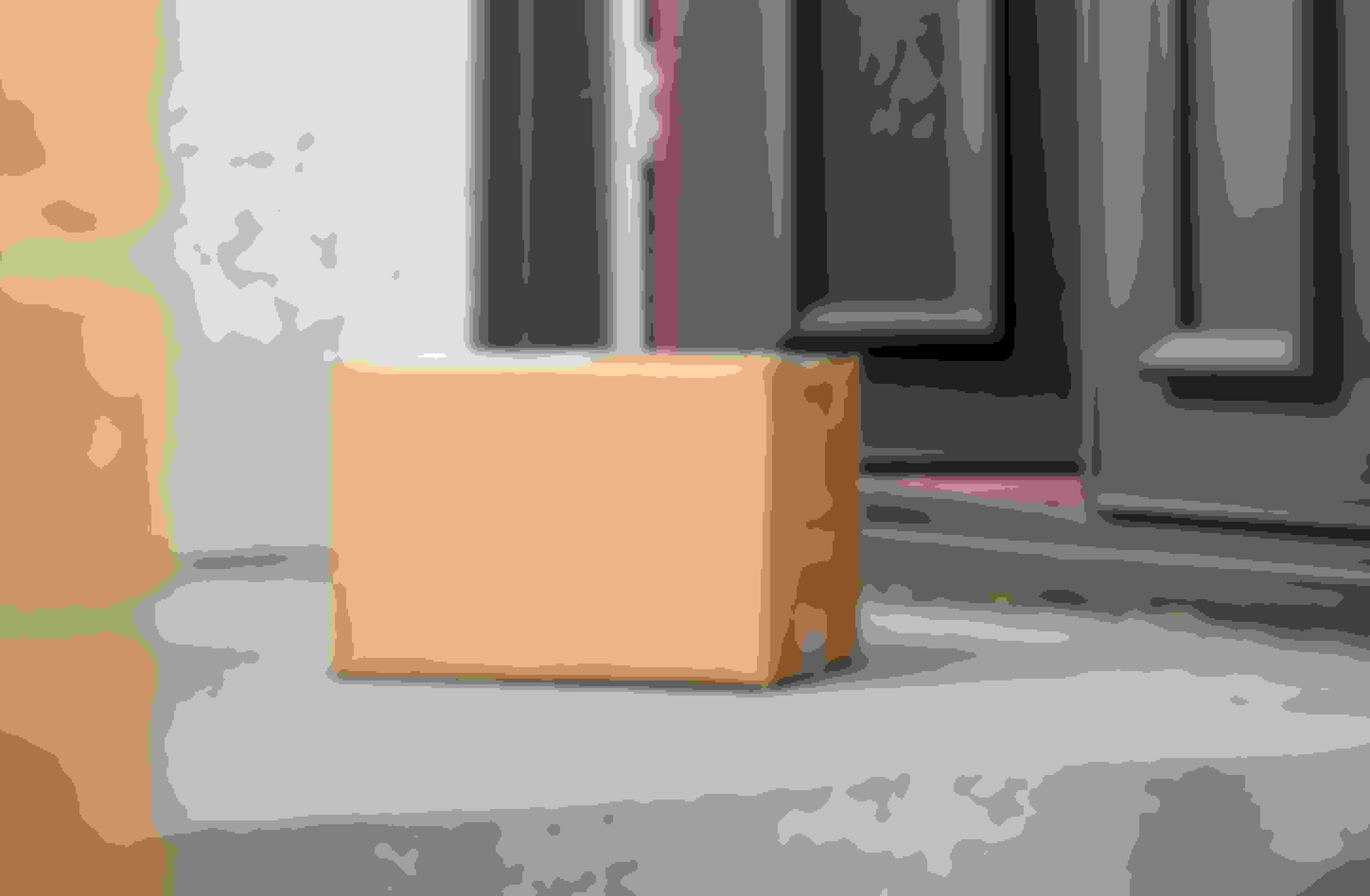 An image of a Cove migraine treatment box on a doormat, next to a pair of wellington boots and a plant.