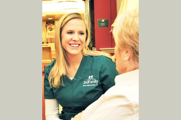 A 2nd Family of Central Maryland caregiver smiling with an elderly woman client.