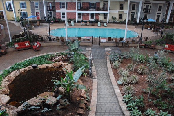 24,000 square foot indoor tropical garden courtyard with comfortable lounging areas including shuffleboard courts, putting green, and heated pool.  Also featuring our Courtyard Café.