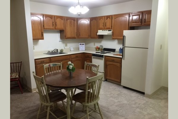 The kitchen of a one bedroom large.  All our small & large one bedrooms and small & large two bedroom apartments have full kitchens including stoves and full size refrigerator plus plenty of cupboard space!