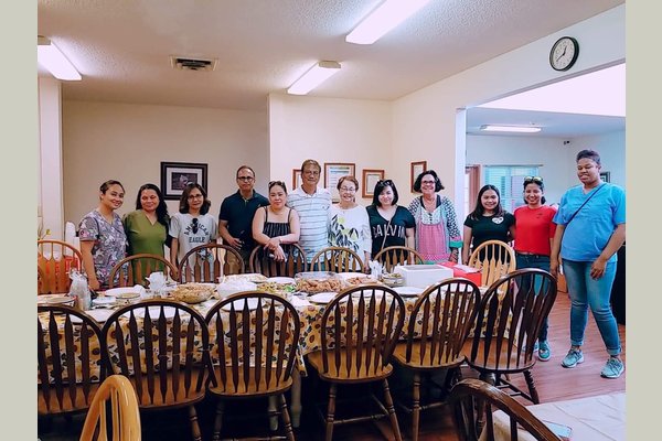 Staff pose before a joint dinner