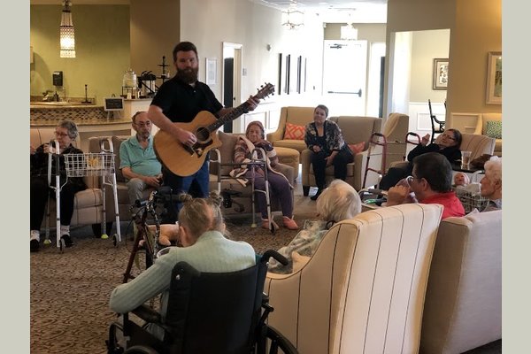 Music is a proven therapy for cognitive loss. Here, our weekly Music Therapist engages our residents with repetitive song.